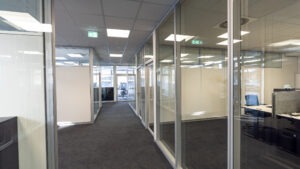 Büroflur mit Glaswänden und Aluminiumrahmen im modernen Innenausbau